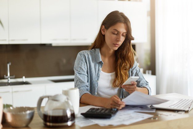 young-woman-checking-her-budget-doing-taxes_273609-12995